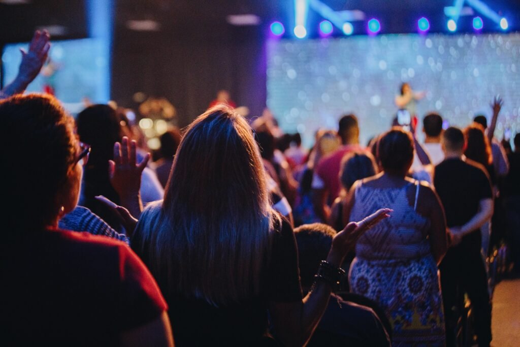 a group of people standing in front of a stage